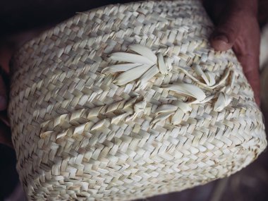 artisans hands intricately weaving a palmito basket, showcasing the traditional craftsmanship and natural materials utilized in this timeless art form clipart