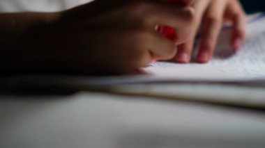 Çizgili bir defter sayfasında kırmızı kalemle yazılmış bir el yazısının yakın çekimi çalışma, öğrenme, yaratıcılık ve organizasyon kavramlarını iletir.