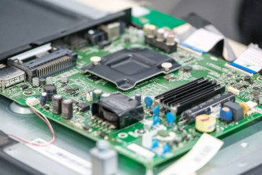 Televizyon tamir teknolojisinin karmaşıklığını gösteren kondansatörler ve rezistansörler de dahil olmak üzere çeşitli elektronik bileşenleri gösteren bir televizyon devre kartının yakın çekim görüntüsü.