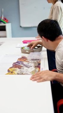 Zihinsel engelliler için bir gündüz merkezindeki bireyler yaratıcı ve destekleyici faaliyetlerde bulunurlar, ilgili bir ortamda gelişmeyi ve sosyal etkileşimi teşvik ederler..