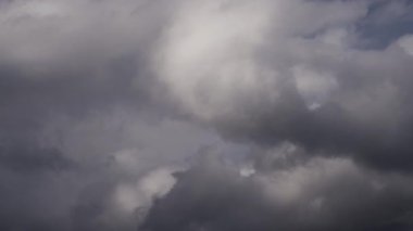 Gökyüzünde biriken karanlık ve uğursuz fırtına bulutlarının dinamik hareketlerini gösteren büyüleyici bir zaman dilimi videosu yaklaşan fırtınanın canlı bir tasvirini sunuyor..