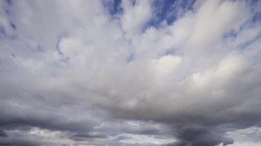 Gökyüzünde yoğun, karanlık fırtına bulutlarının dramatik ve hızlı bir şekilde toplandığını gösteren bir zaman kaydıyla yaklaşan fırtınayı gösteriyor..