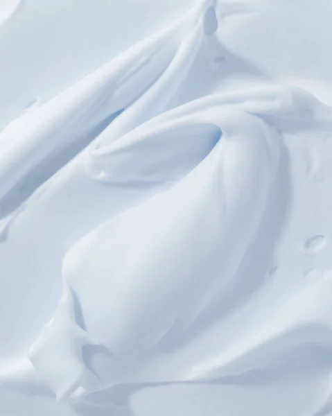 Blue mousse foam creamy texture. Cosmetic cleanser, soap, cream, shampoo sample. Foamy skincare product smear smudge