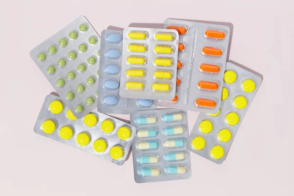 Gyógyszerészeti Színes Tabletták Kapszulák Buborékcsomagolásban Rózsaszín Alapon — Stock Fotó