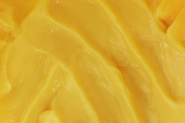 Beauty cream texture. Yellow lotion, moisturizer, skin care cosmetic product smear background