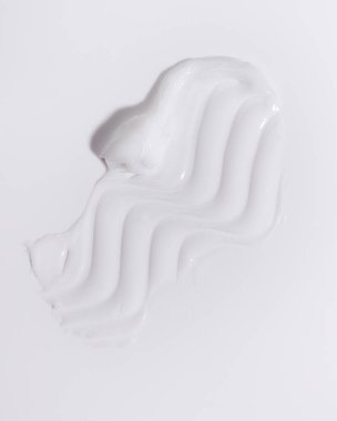White beauty cream smear smudge on white background. Cosmetic skincare product texture. Face cream, body lotion swipe swatch 