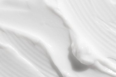 Beyaz nemlendirici kremin yakın çekim dokusu. Cilt bakım ürünü geçmişi. Yüz maskesi