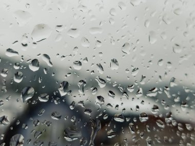 Üzerinde yağmur damlaları olan bir pencere.