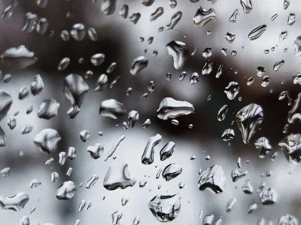 Üzerinde yağmur damlaları olan bir pencere.