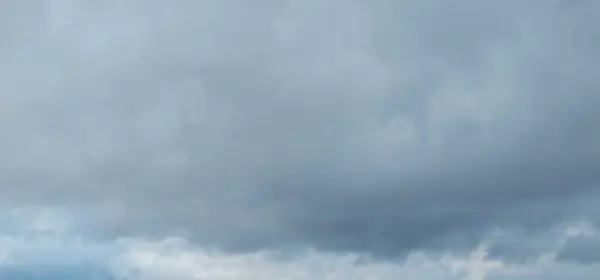 a person flying a kite on a cloudy day