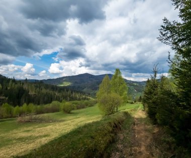 Dağları ve mavi gökyüzü olan güzel bir manzara.