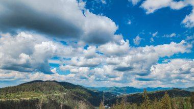 Mavi gökyüzü ve bulutlu dağ manzarası