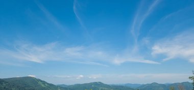 Bulutlu ve mavi gökyüzü olan dağ manzarası