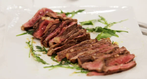 Roastbeef. Entrecote. Beef. Main courses: Fillet with rucola and extravirgin oil. Italian cuisine