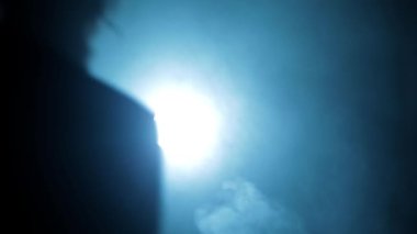 Shot of a young hitman in a blue colored coat with his gun resting on his shoulder HD footage.