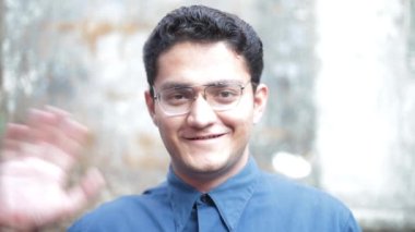 Portrait shot of a happy teenage student smiling and greeting, Male happy teenager.