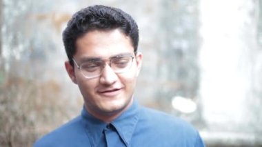 Portrait shot of a happy teenage student smiling and greeting, Male happy teenager.