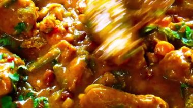 Shot of freshly prepared FISH DHOKLA or FISH DHOKRA an Indian dish similar to stew with all the vegetables and fish pieces in it. HD footage.