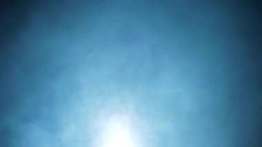 Cinematic shot of a young man in a blue suit with long hair and blood on his face, coming upstairs looking sideways, and keeping a gun on his shoulder. HD footage with smoke element 24FPS.