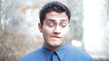 Portrait shot of a male making weird facial expressions. Hd footage 24FPS.  Man making expressions.