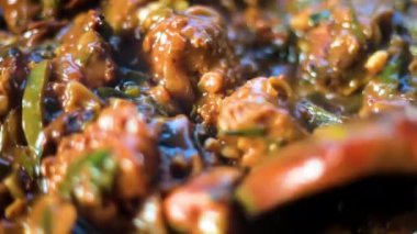 Close-up shot of chili chicken gravy on a plate. Hot spicy chili chicken.