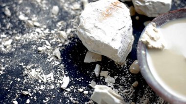 Multani mitti ya da Fuller 'in toprağı siyah bir yüzey üzerindedir ve yüz maskeleri ve yüz maskeleri için kullanılan kilden bir kaseye yapıştırılmıştır..