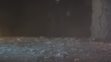 Enkazla dolu bir odada bilinmeyen bir adam dolaşıyor.