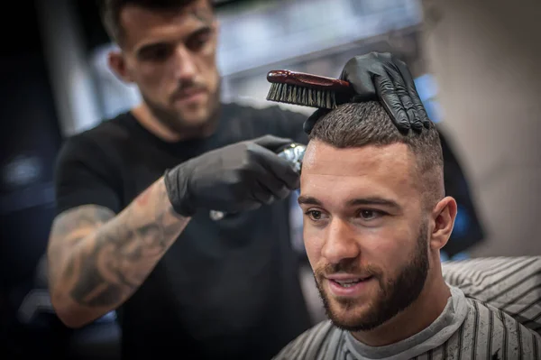 stock image Modern urban hairdresser cut hair with hair trimmer in professional hairdressing salon and studio. Close-up detail view