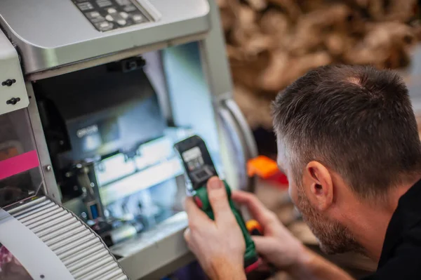 stock image All machines nead maintains. Professional technician troubleshooting and repair the machines in the printing house.