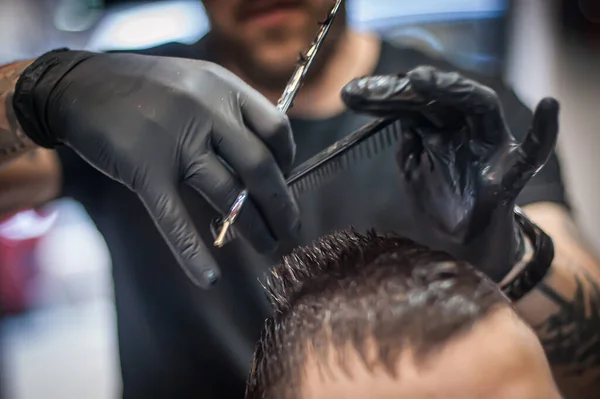 stock image Modern urban hairdresser cut hair with hair scissors in professional hairdressing salon and studio. Close-up detail view