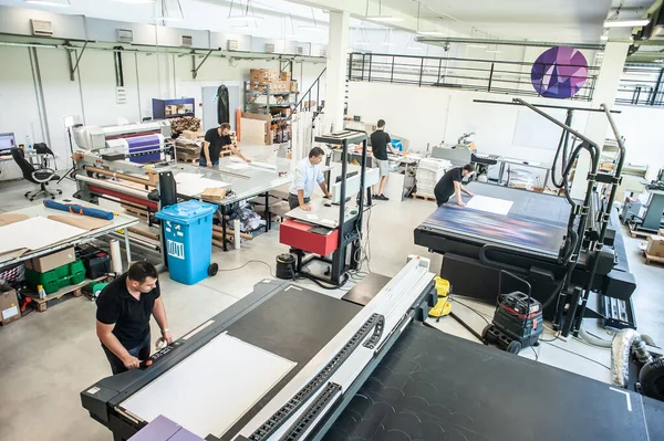 stock image In a large modern printing plant, operators work on various types of machines for printed material