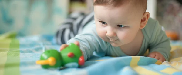 Portrait Cute Baby Boy Playing Colorful Toys Home While Lies — Stock Photo, Image