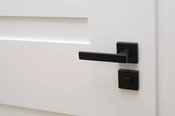 stock image white door with black handle