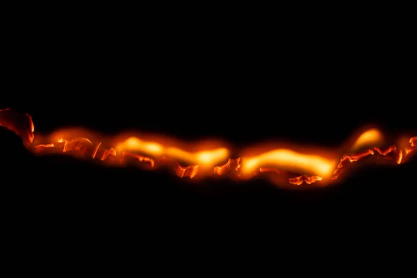 burning paper, glowing edge of paper on a black background