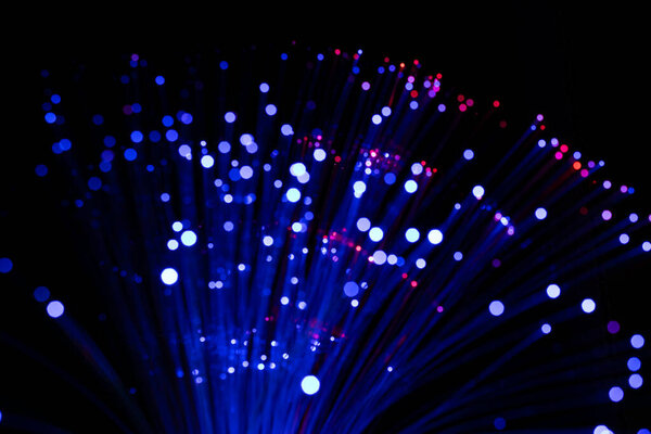 Fiber optic cables glowing blue.  bokeh light spots