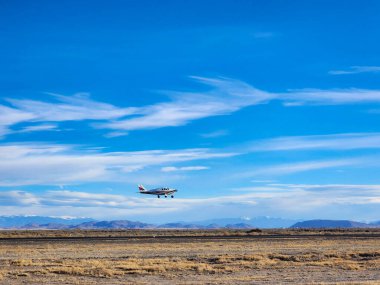 airplane flying in the sky at the beach