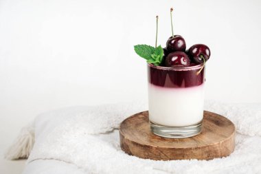 Gelatin dessert. Yoghurt and cherry jelly in a glass.