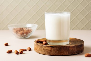 Almond milk in a glass with nuts. Vegan milk.