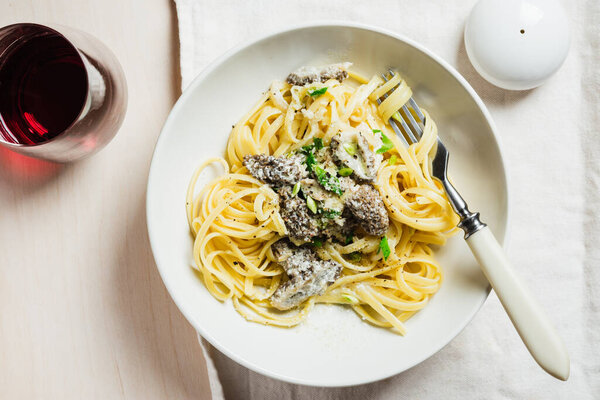 Linguine pasta with morel mushrooms, creamy sauce and wine.