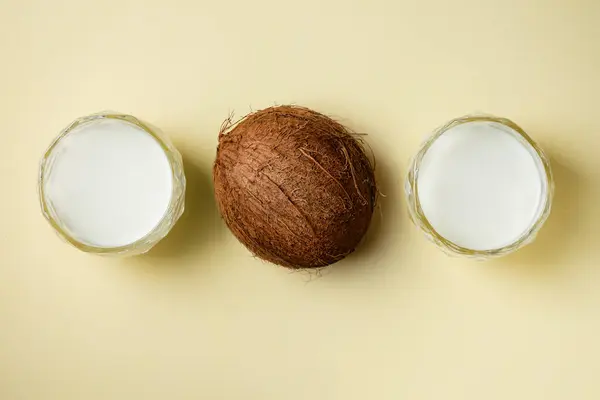 Vegan coconut milk yogurt and coconut on a yellow background.