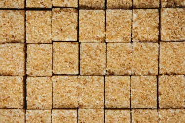 Kahverengi kamış şeker küpleri, doku, yemek arkaplanı.