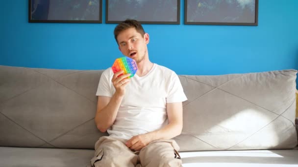 Man Sits Couch Looks Comically Pop Tired Trends — Stock Video
