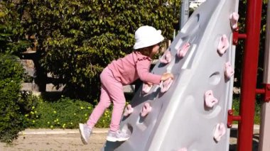 Çocuk parkında. Tırmanma duvarına tırmanıyorum. Açık hava oyunları