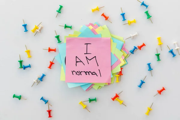 I am normal phrase hand written on a sticky note