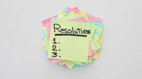 Handwritten resolutions list 1 2 3 on a sticky notes