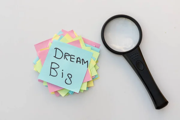 Dream Big handwritten on a sticky note. Searching concept for big dreams or motivational slogan