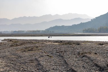 Sabahın erken saatlerinde nehrin güzel manzarası. İşçi denizden kum getirir.