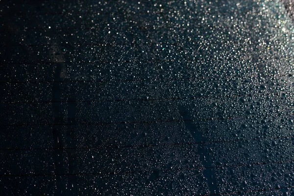 Car rear window with rain drops texture background