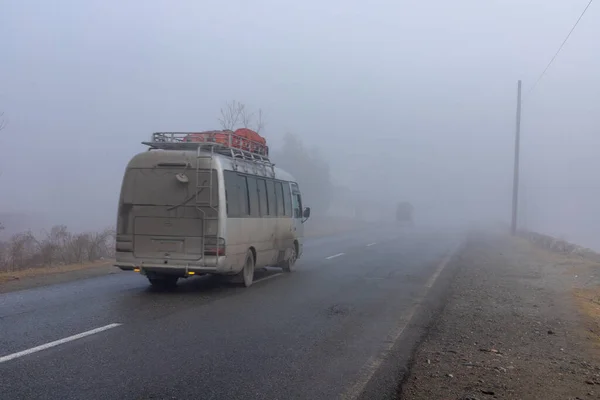 Bus in foggy weather with low poor visibility on a road in swat valley, Pakistan