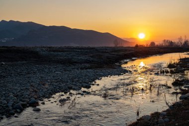 Sunset with reflections in a lake with beautiful color in the sky